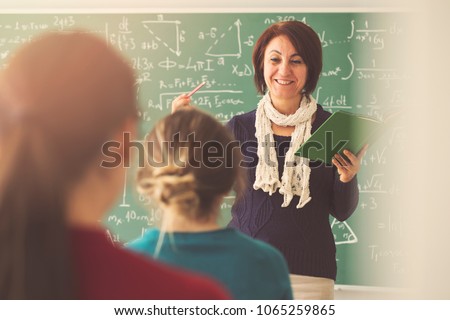Teacher giving lesson to students in classroom
