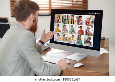 Teacher Giving Online School Lesson During Quarantine And Social Distancing Due To Covid-19 Pandemic. Pupils Studying At Home Via Video Conference