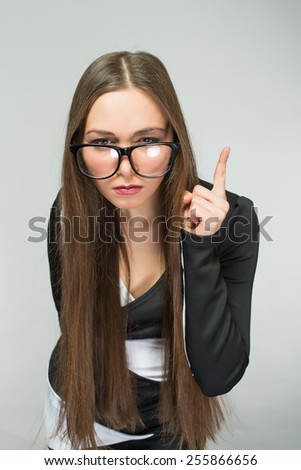 teacher in glasses shakes his finger in the studio with glasses