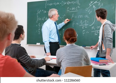 Teacher With A Group Of High School Students In Classroom