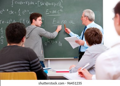 Teacher With A Group Of High School Students  In Classroom