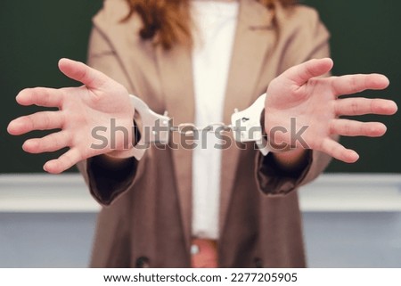Teacher in handcuffs, concept of crime and arrest of teachers