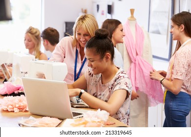 Teacher Helping College Students Studying Fashion And Design