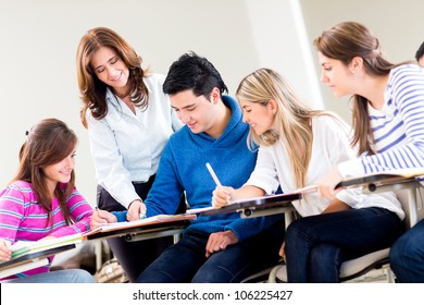 Teacher helping a group of students at the university