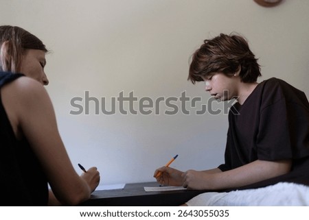 Teacher helping student with learning difficulties doing homework