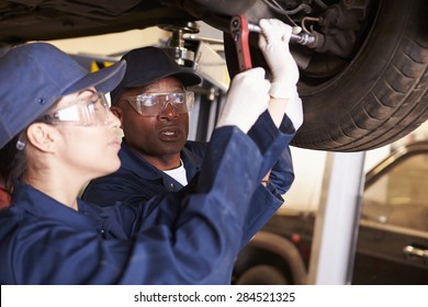 Teacher Helping Student Training To Be Car Mechanics - Shutterstock ID 284521325