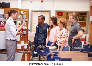 Teacher Helping Students Training To Be Electricians