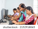 Teacher helping or teaching students during computer class training - concept of learning, personal support and technology.