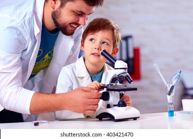 Teacher Helps Kid To Conduct Experiment With Microscope