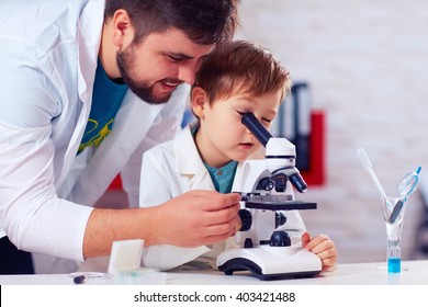 teacher helps kid to conduct experiment with microscope
