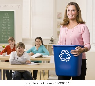 Teacher Holding Recycling Bin