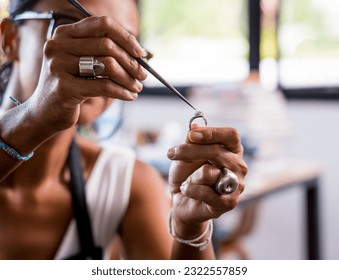 Teacher jeweler and student make jewelry in workshop - Powered by Shutterstock