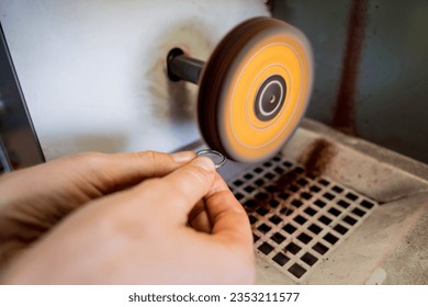 Teacher jeweler and student polishing jewelry in workshop - Powered by Shutterstock