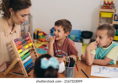 Teacher And Kids In Kindergarden