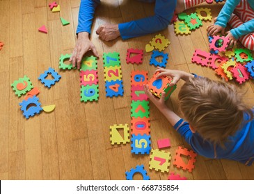 Teacher And Kids Playing With Number Puzzle