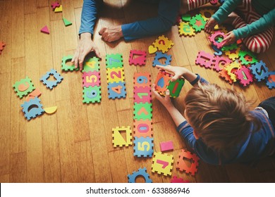 Teacher And Kids Playing With Puzzle, Early Learning