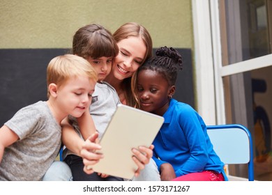 Teacher Or Kids Using Tablet Computer Have Fun With Social Media