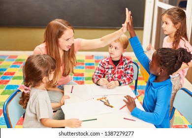 Teacher Or Kindergarten Teacher And A Girl Give Themselves A High Five In Kindergarten