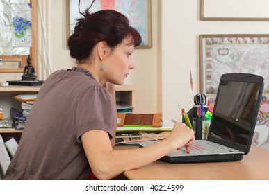 teacher with laptop in classroom