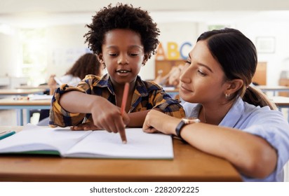 Teacher, learning and helping black kid in classroom for knowledge, studying or assessment. Question, development and boy or student with woman for education pointing in notebook in kindergarten. - Powered by Shutterstock