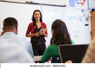 Teacher Listening To Students At An Adult Education Class