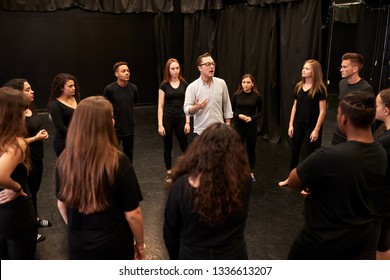 Teacher With Male And Female Drama Students At Performing Arts School In Studio Improvisation Class - Powered by Shutterstock