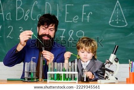 teacher man with little boy. Biology Science lab. Scientist research and experiments Back to school. father and son at school. learning chemistry in school laboratory. Science is always the solution
