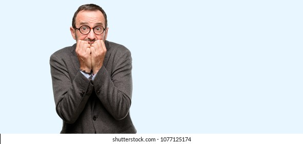 Teacher Man Using Glasses Terrified And Nervous Expressing Anxiety And Panic Gesture, Overwhelmed Isolated Over Blue Background