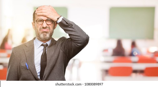 Teacher Man Using Glasses Terrified And Nervous Expressing Anxiety And Panic Gesture, Overwhelmed At Classroom