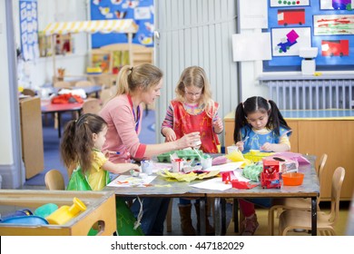 Teacher and nursery students doing arts and crafts in the classroom.  - Powered by Shutterstock