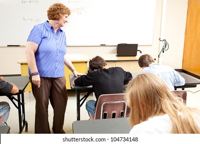 Teacher Observes Her High School Class As They Are Taking A Test.