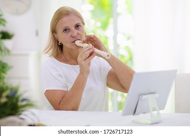 Teacher Playing Flute In Front Of Computer. Online Music Tuition. Remote Learning From Home. Art Lesson For Kid. Video Chat Conference. Creative Freelance Work From Home. Classical Education.