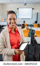 Teacher Posing With Her Tablet At School