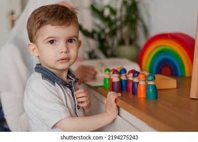 Teacher And Preschool Child Playing Together With Colorful Toys In The Montessori School Classroom.