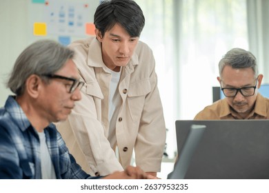 Teacher programmer teaching coding to senior adult students in a tech workshop, fostering innovation and digital learning in a community setting.
