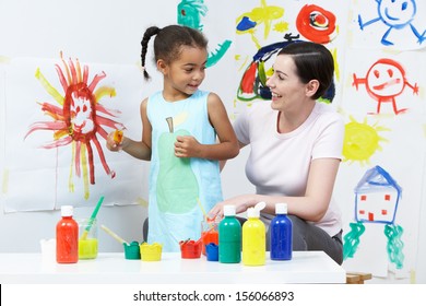 Teacher And Pupil In Pre School Art Class