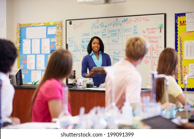 Teacher And Pupils In High School Science Class