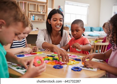 Teacher And Pupils Using Flower Shapes In Montessori School - Shutterstock ID 641732287