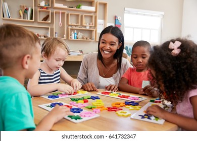 Teacher And Pupils Using Flower Shapes In Montessori School - Shutterstock ID 641732347