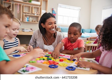 Teacher And Pupils Using Flower Shapes In Montessori School - Shutterstock ID 641733208