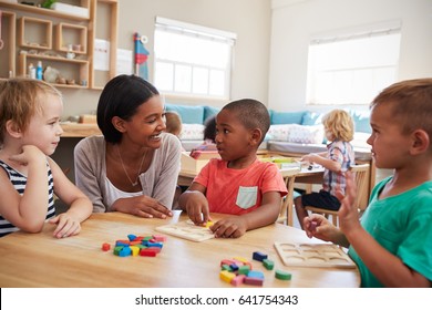 Teacher And Pupils Using Wooden Shapes In Montessori School - Shutterstock ID 641754343
