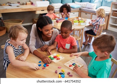 Teacher And Pupils Using Wooden Shapes In Montessori School - Shutterstock ID 641754352