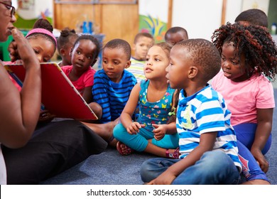 Teacher Reading A Book With A Class Of Preschool Children