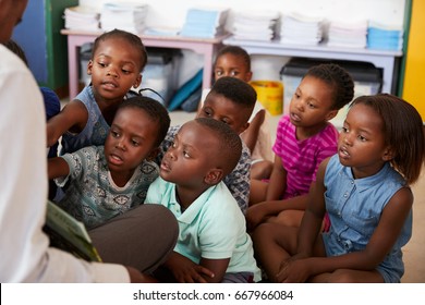 Teacher reading book to elementary school children in class