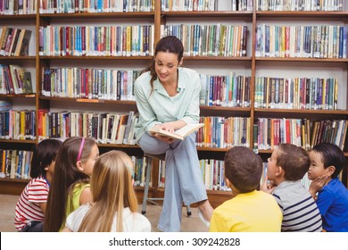 Teacher Reading Her Pupils A Story At The Elementary School