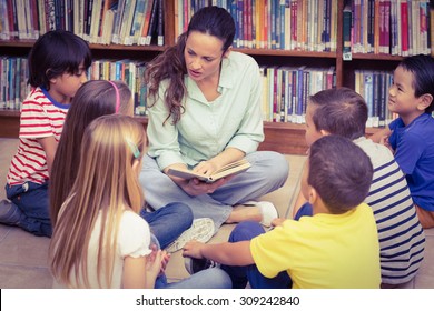 Teacher Reading Her Pupils A Story At The Elementary School