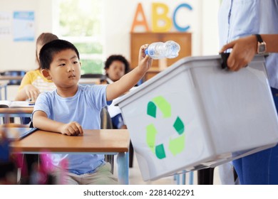 Teacher, recycle bin and kid in classroom throwing trash for cleaning, climate change or eco friendly in school. Recycling plastic, sustainable learning or education with boy student in kindergarten. - Powered by Shutterstock