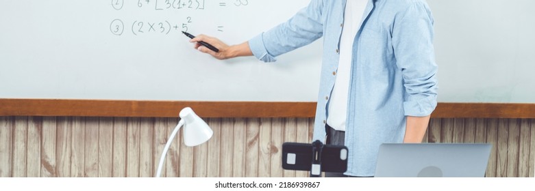 Teacher remotely using camera to stream lesson working call video conference teaching online in blackboard to student
