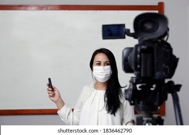 Teacher With Respiratory Protection Mask During Presentation Of Online Virtual Class