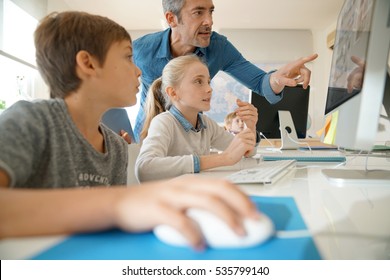 Teacher with school kids in computer laboratory